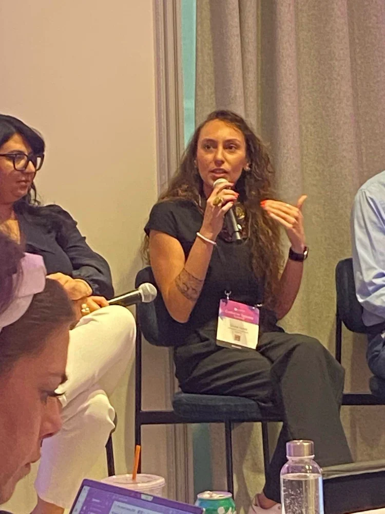 Gozde Gorce speaking at a customer success summit panel